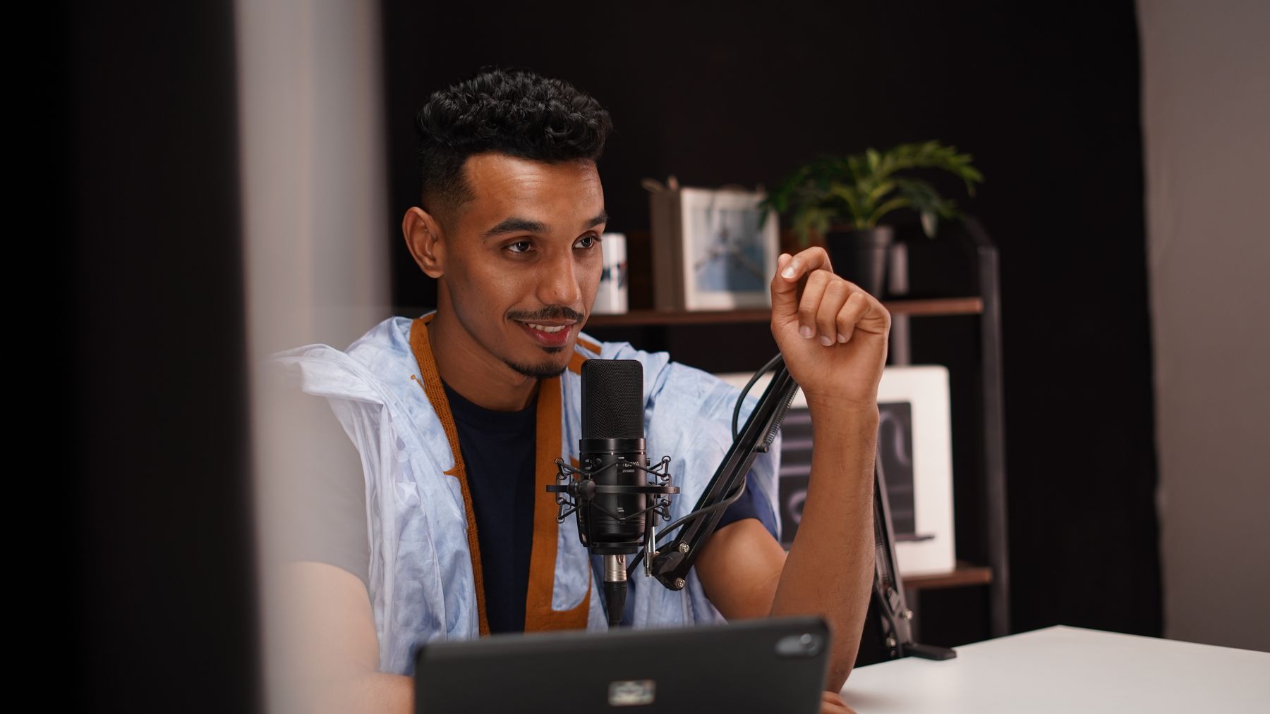 Speaker talking into a studio microphone